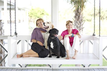 katie and diane in the swing with sailor, a rescued lab. Pack your wags for a dog friendly mermaid getaway